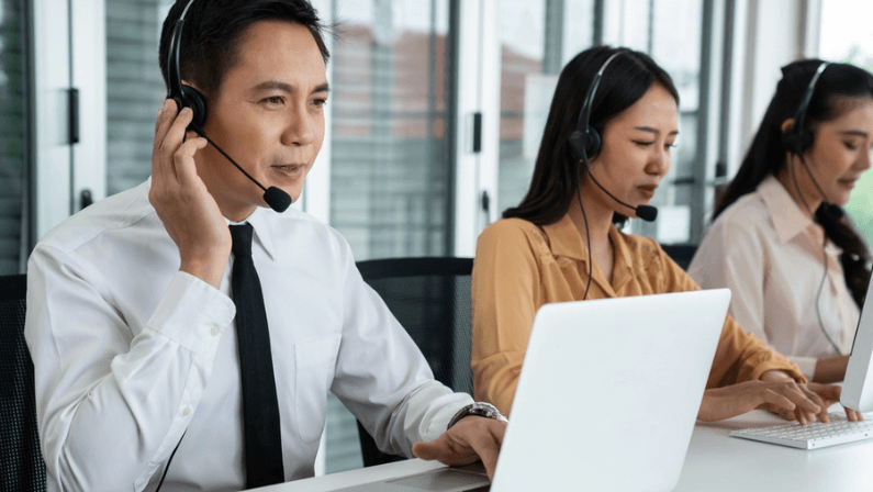 Business people wearing headset working actively in office . Call center, telemarketing, customer support agent provide service on telephone video conference call