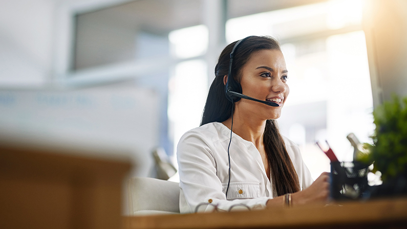 Customer service, virtual assistant or happy woman in call center consulting, speaking or talking at help desk. Contact us, friendly agent or sales consultant in telemarketing or telecom company