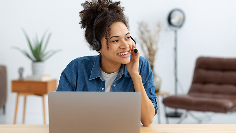 Portrait of happy African American female employee customer support services in headset, online consultation. Woman call center. Female customer support or sales agen