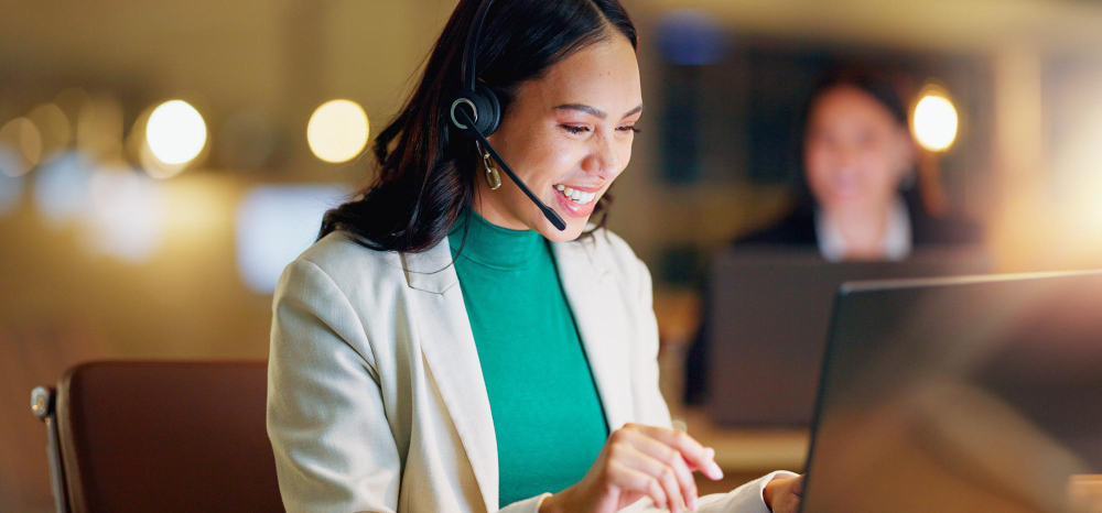 Happy woman call center and communication with laptop at night in office for customer service and CRM