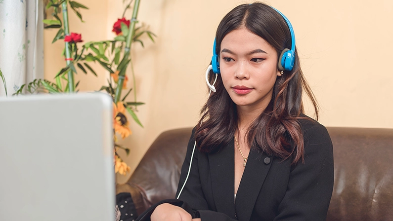 A lovely and hardworking virtual assistant working on her laptop. An attractive female professional wearing a black blazer.