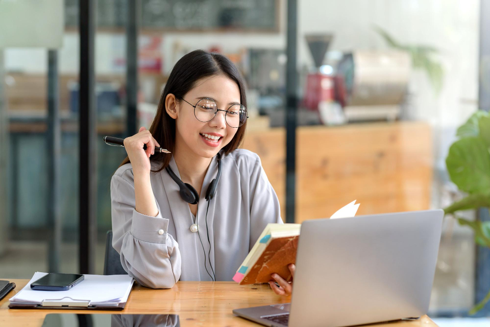 woman wearing headphones looking at webcam looking at camera during virtual meeting or video call talk