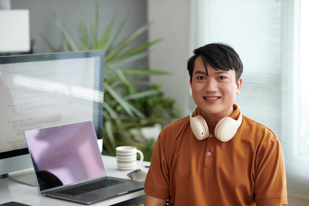  sitting at desk in his home office