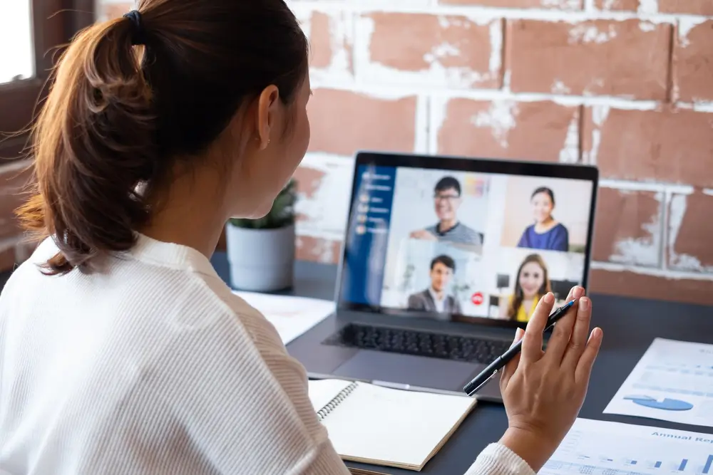 Asian businesswoman work at home and virtual video conference meeting with colleagues business people