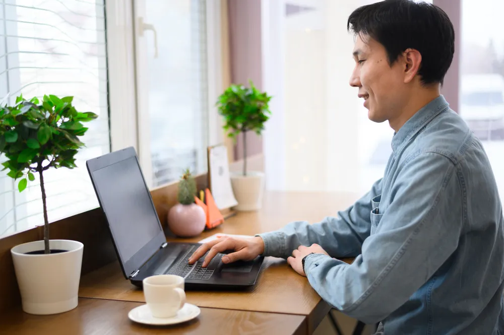 Side view man using laptop