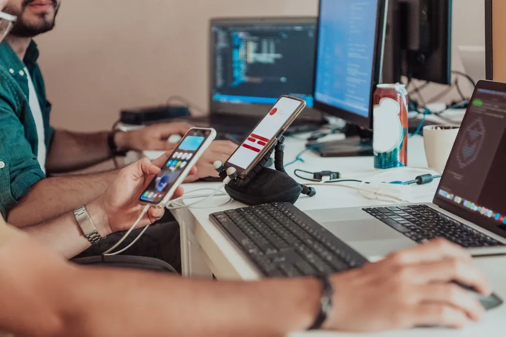 Programmers engrossed in deep collaboration, diligently working together