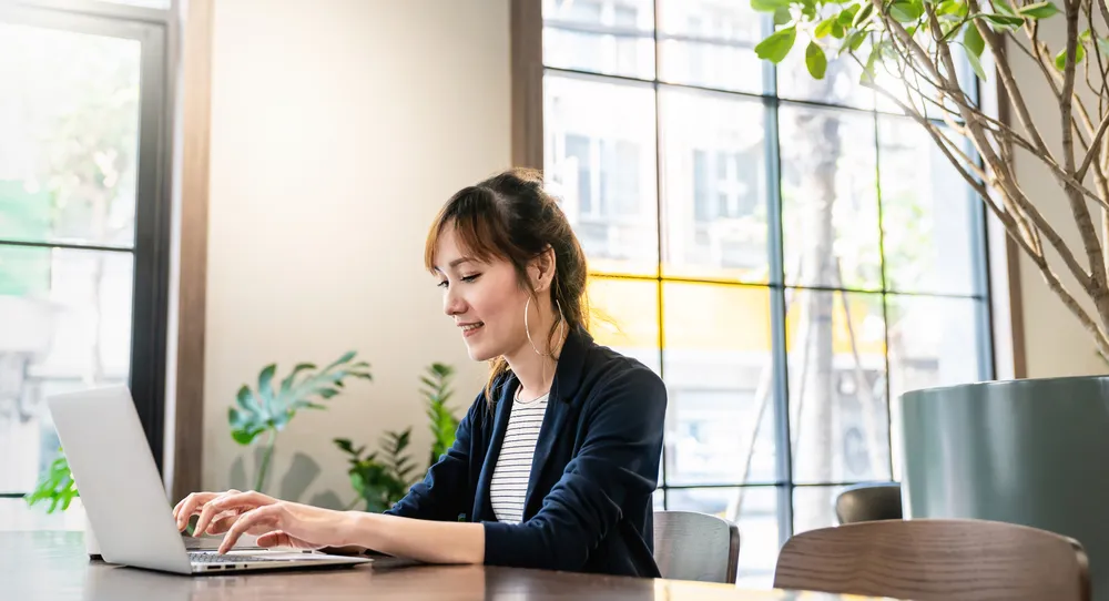 Smiling beautiful woman in her laptop as a virtual assistant