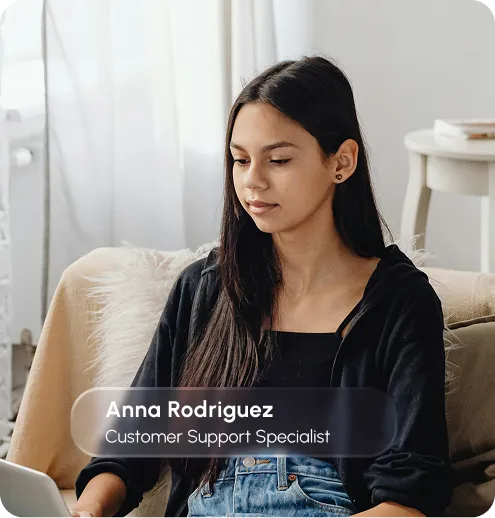 Anno Rodriguez, a customer support specialist, assisting a client with inquiries at a desk with a computer.