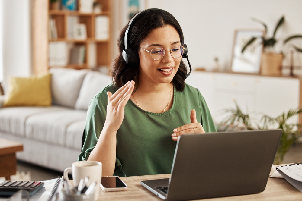 Sales support virtual assistant in front of her laptop during call