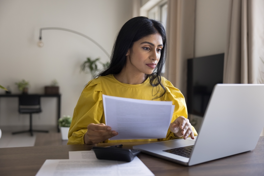 Busy millennial woman working from home