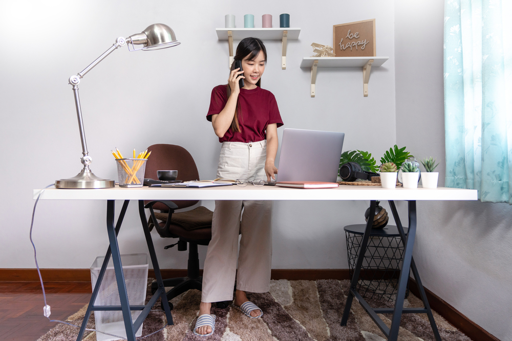 A young, beautiful business asian girl use a laptop working remotely