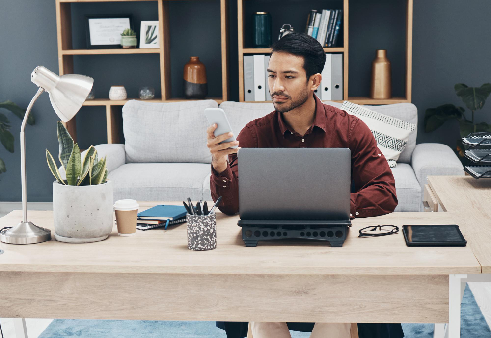 Man holding a phone and texting in office