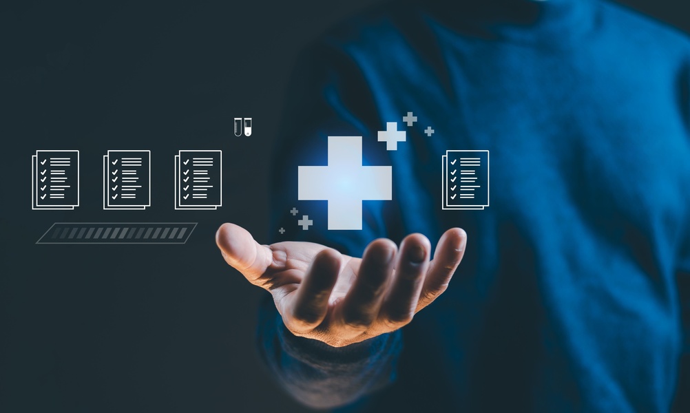 Modern digital healthcare concept featuring a hand presenting a glowing medical cross