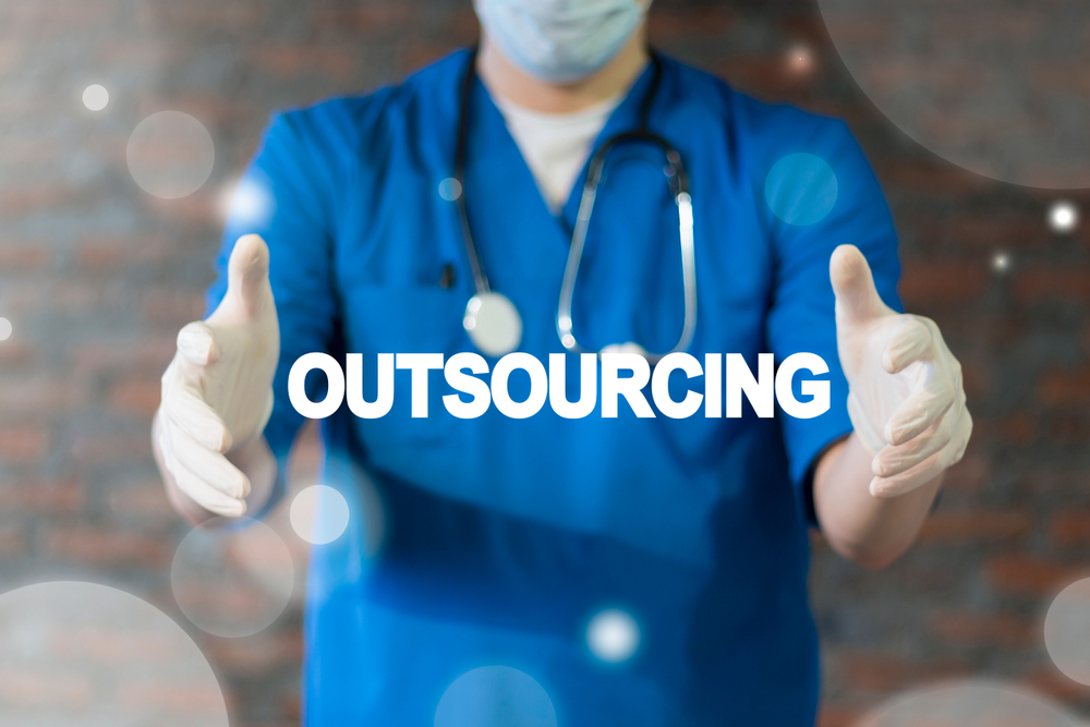Doctor offers outsourcing text icon on a virtual interface.
